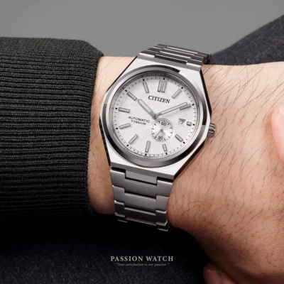 citizen zenshin nj0180 80a 4 Cận cảnh đeo trên tay đồng hồ Citizen Zenshin NJ0180-80A với nền trắng cát sần, kim giờ phút trung tâm, kim giây nhỏ tại góc 4h30 và ô lịch ngày sắc nét tại góc 3h